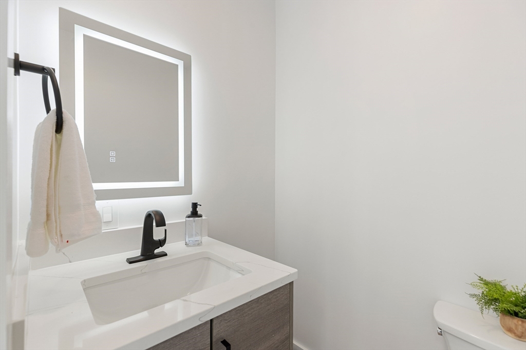 656 Mystic Avenue, Unit B Somerville, MA 02145 - Photo 11 of 40 a bathroom with a sink and a mirror