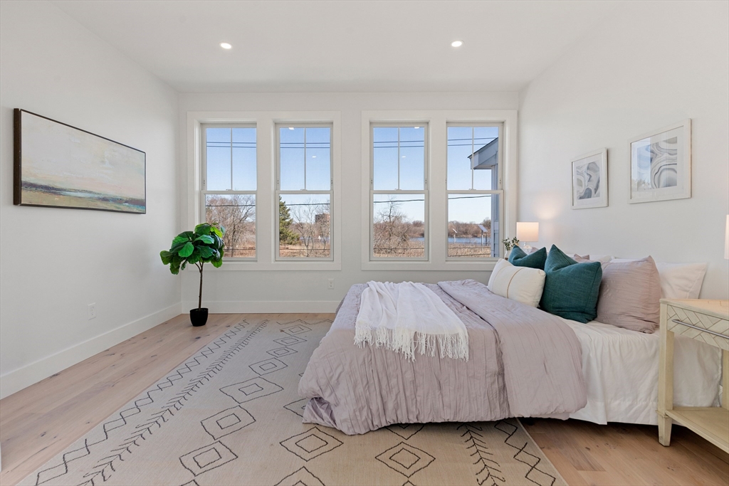 656 Mystic Avenue, Unit B Somerville, MA 02145 - Photo 16 of 40 a bedroom with a bed painting and window