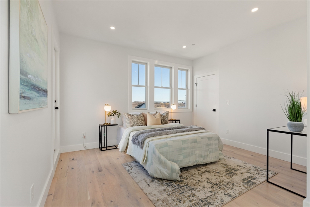 656 Mystic Avenue, Unit B Somerville, MA 02145 - Photo 20 of 40 a bedroom with a bed and a window