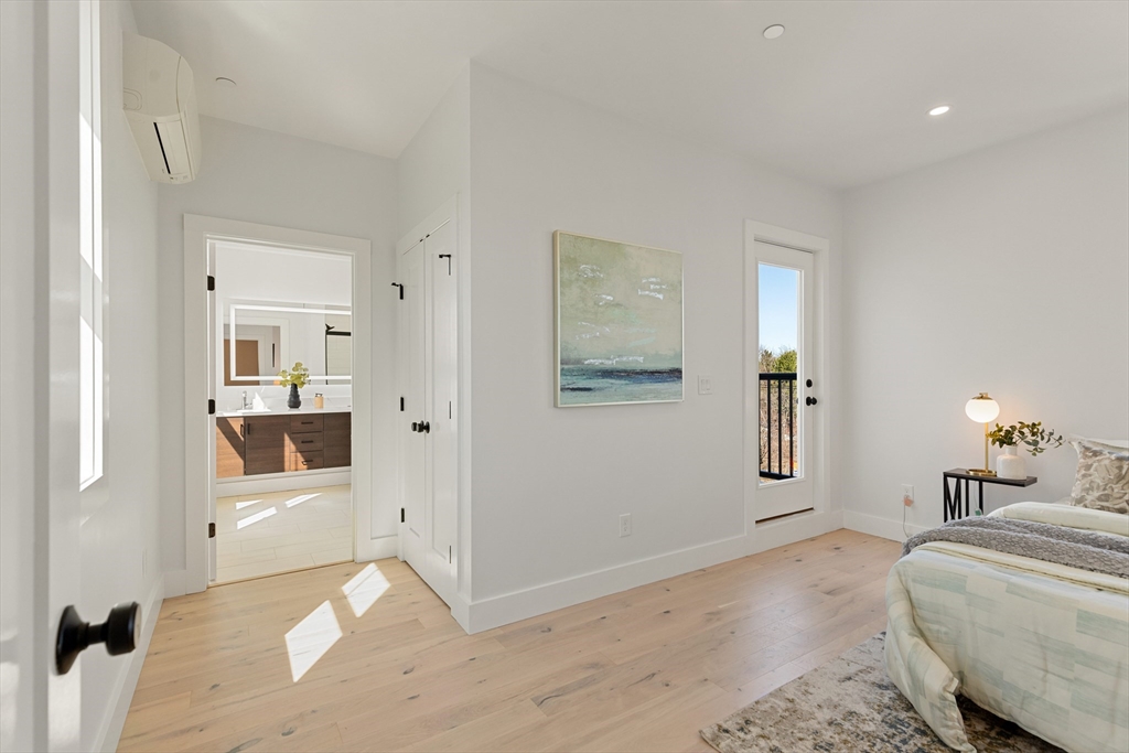 656 Mystic Avenue, Unit B Somerville, MA 02145 - Photo 21 of 40 a bedroom with a bed and a view of bathroom