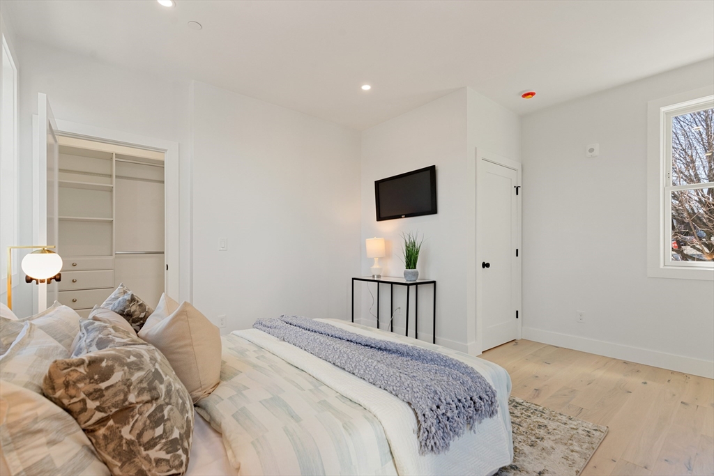 656 Mystic Avenue, Unit B Somerville, MA 02145 - Photo 23 of 40 a bedroom with a bed and a tv