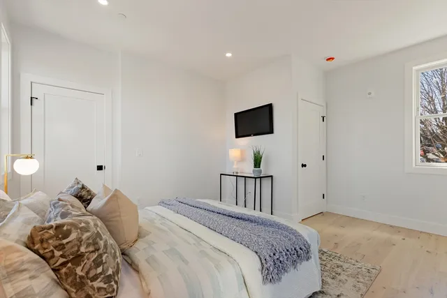 a bedroom with a bed and a tv