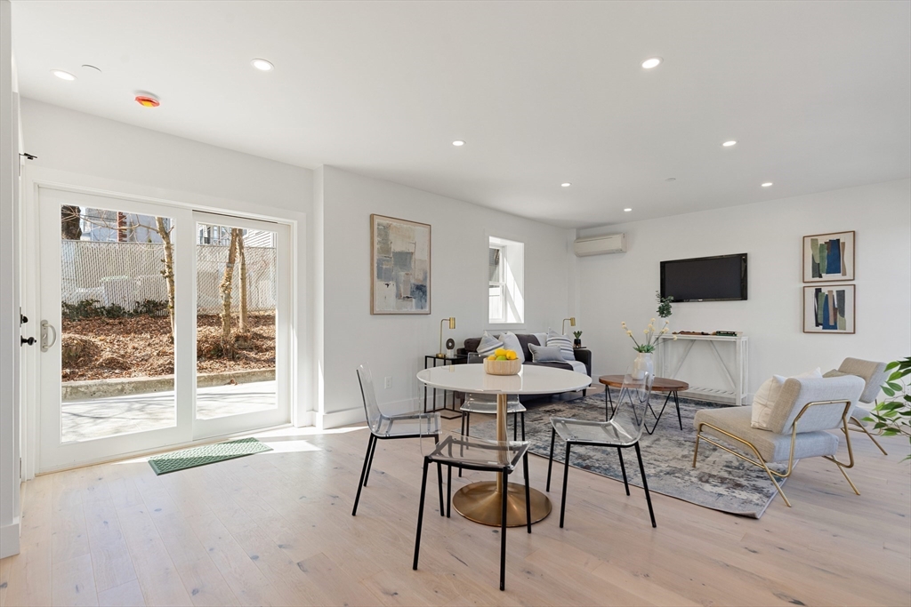 656 Mystic Avenue, Unit B Somerville, MA 02145 - Photo 3 of 40 a view of a dining room with furniture window and outside view