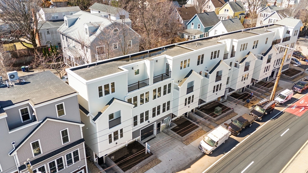 656 Mystic Avenue, Unit B Somerville, MA 02145 - Photo 38 of 40 a large building with a lot of windows