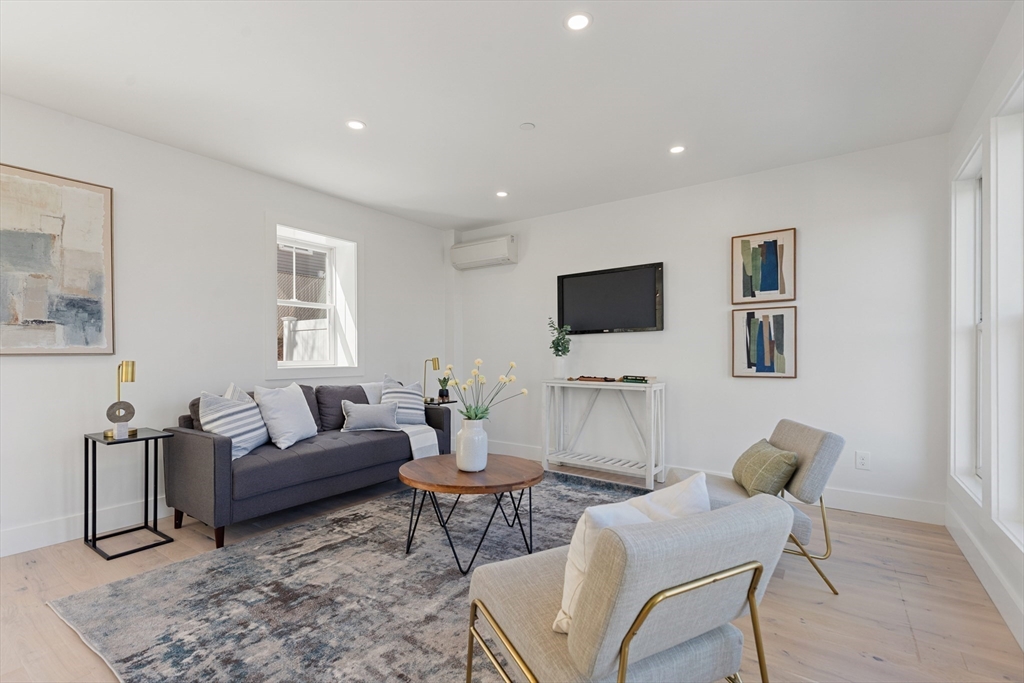 656 Mystic Avenue, Unit B Somerville, MA 02145 - Photo 5 of 40 a living room with furniture and a flat screen tv