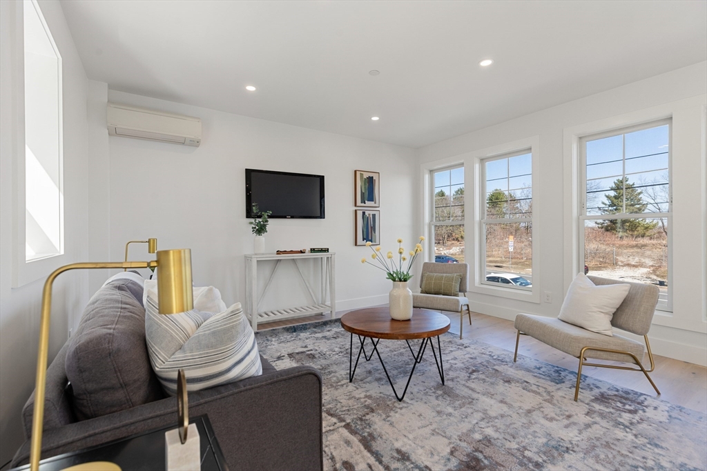 656 Mystic Avenue, Unit B Somerville, MA 02145 - Photo 7 of 40 a living room with furniture and a flat screen tv