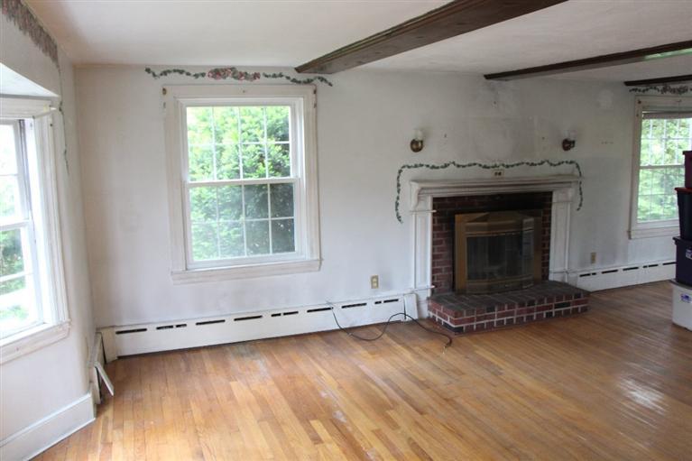 1 Cross Road Bourne, MA 02532 - Photo 13 of 22 an empty room with wooden floor fireplace and windows