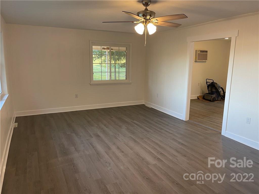 3180 Foster Road Cleveland, NC 27013 - Photo 11 of 16 wooden floor in an empty room with a window