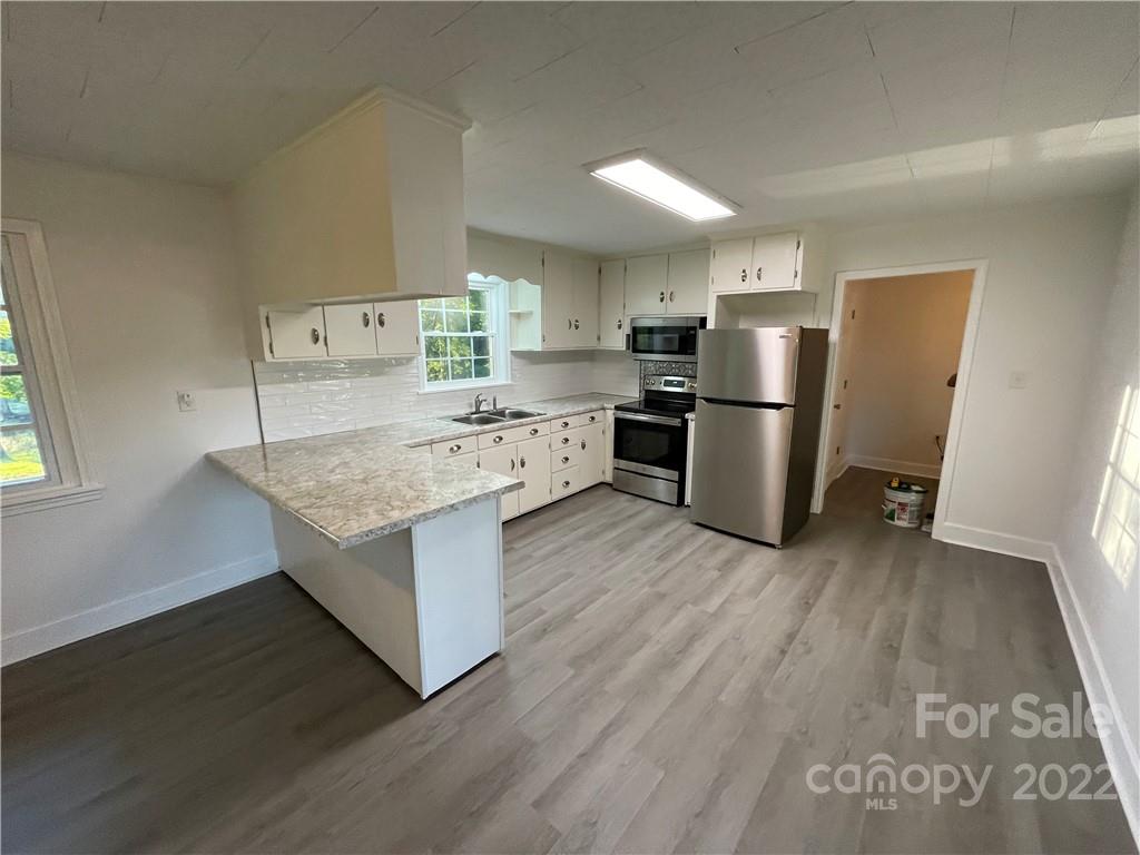 3180 Foster Road Cleveland, NC 27013 - Photo 3 of 16 a kitchen with a refrigerator sink and stove