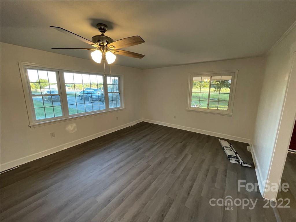 3180 Foster Road Cleveland, NC 27013 - Photo 5 of 16 a view of an empty room with wooden floor and a window