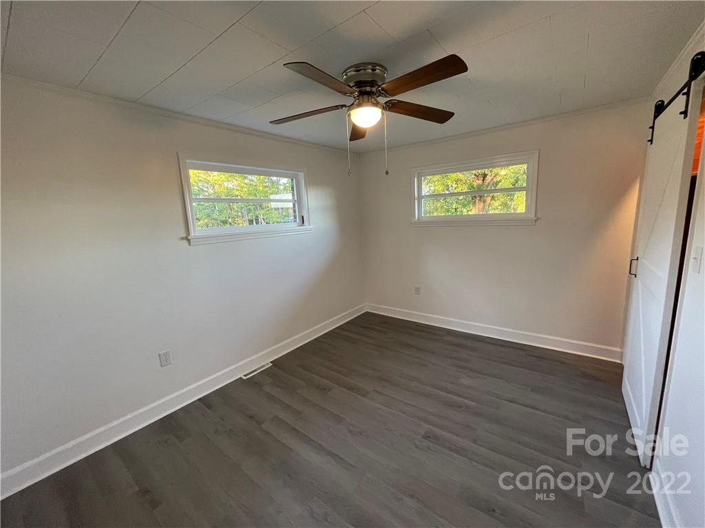 3180 Foster Road Cleveland, NC 27013 - Photo 7 of 16 an empty room with wooden floor and windows