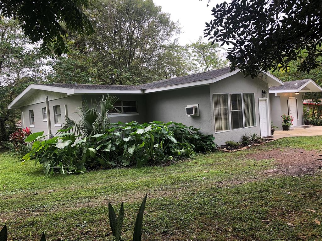 a front view of house with yard and green space
