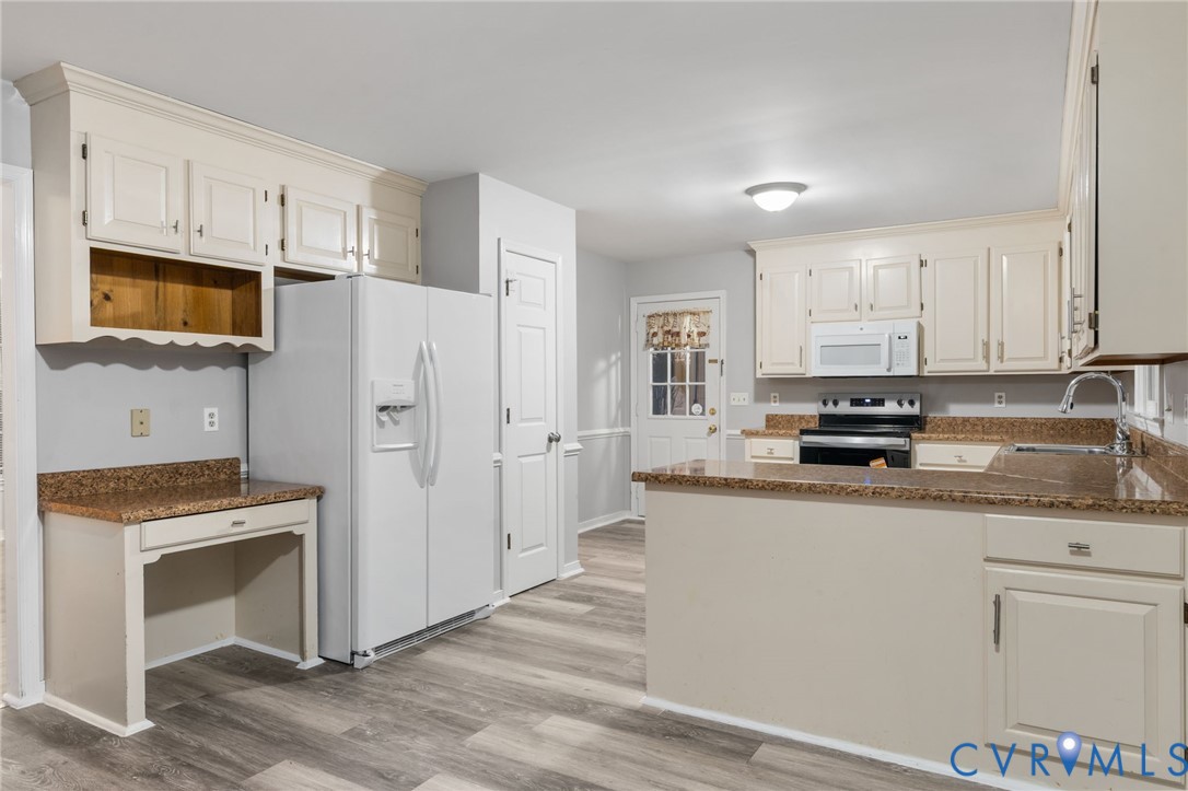 10204 Stonecrest Road Chesterfield, VA 23236 - Photo 12 of 36 a kitchen with stainless steel appliances a stove refrigerator sink and microwave