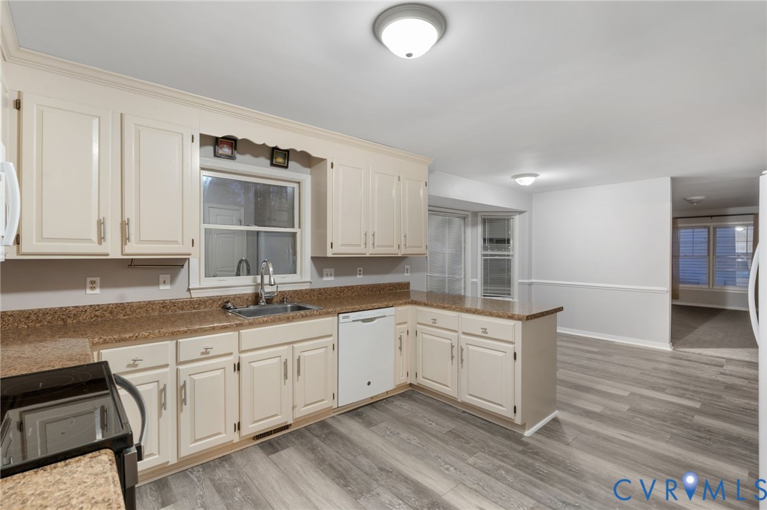 10204 Stonecrest Road Chesterfield, VA 23236 - Photo 14 of 36 a kitchen with a sink stove and cabinets