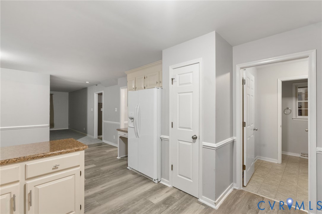 10204 Stonecrest Road Chesterfield, VA 23236 - Photo 16 of 36 a view of a kitchen with refrigerator and wooden floor