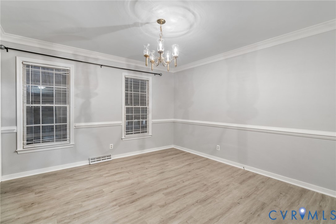 10204 Stonecrest Road Chesterfield, VA 23236 - Photo 18 of 36 a view of an empty room with a window and wooden floor