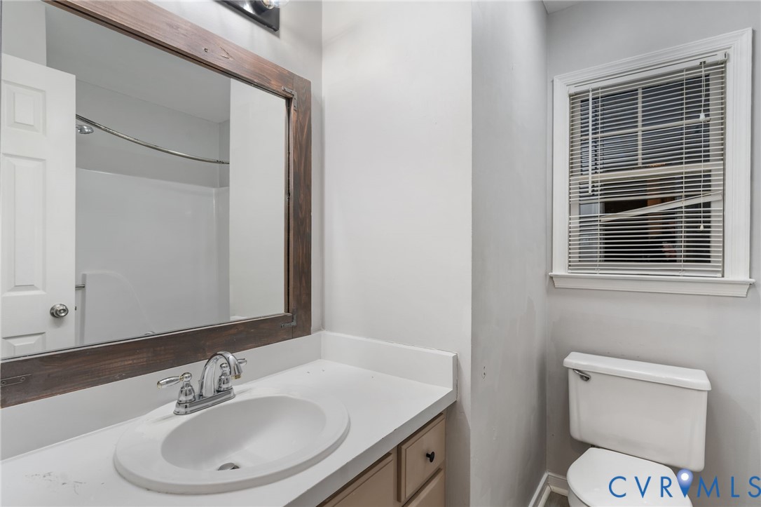10204 Stonecrest Road Chesterfield, VA 23236 - Photo 22 of 36 a bathroom with a sink a toilet and a mirror