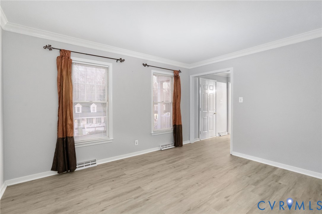 10204 Stonecrest Road Chesterfield, VA 23236 - Photo 6 of 36 a view of an empty room with wooden floor and a window