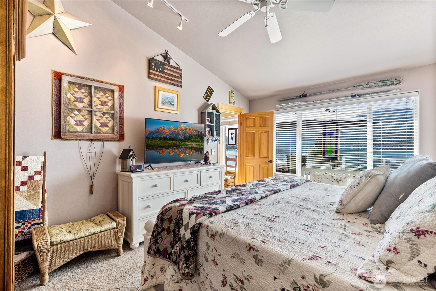 563 Topaz Place Manson, WA 98831 - Photo 19 of 38 a bedroom with a bed and a flat screen tv