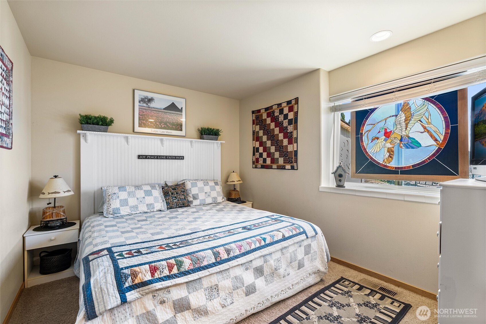 563 Topaz Place Manson, WA 98831 - Photo 29 of 38 a bedroom with a bed and painting on the wall