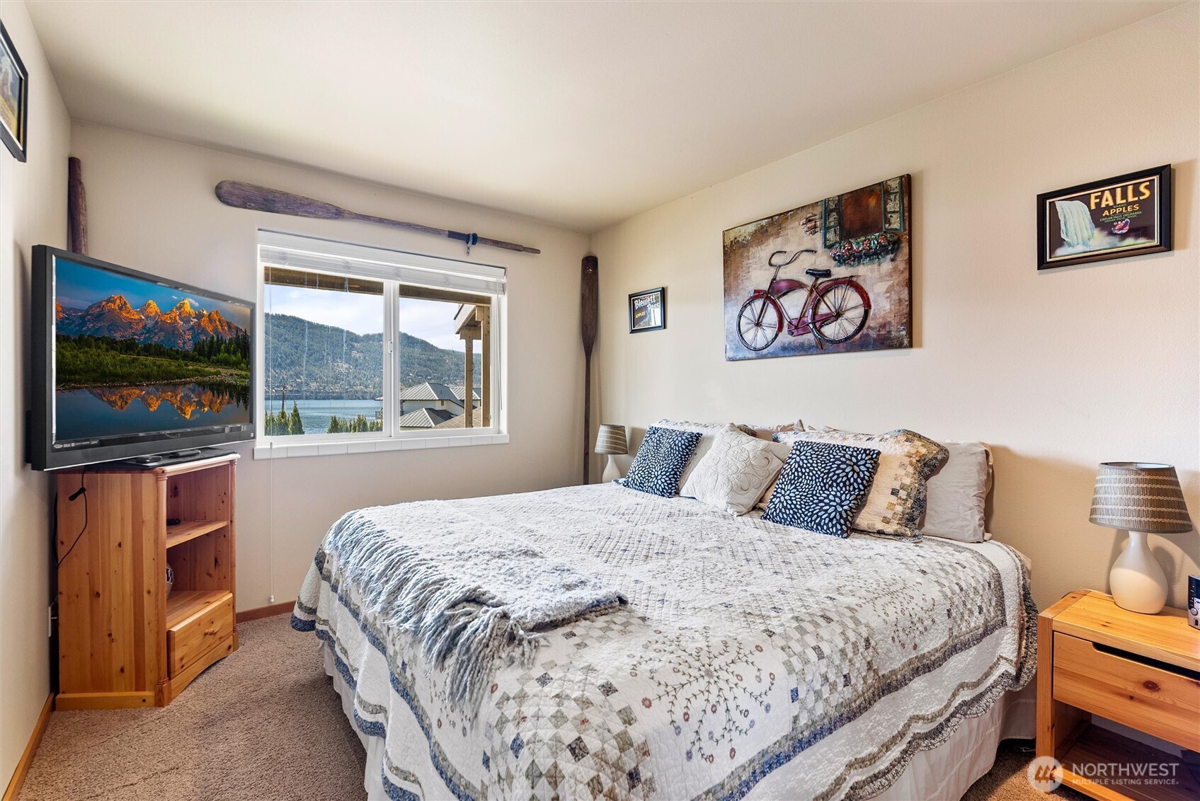 563 Topaz Place Manson, WA 98831 - Photo 31 of 38 a bedroom with a bed and a flat screen tv