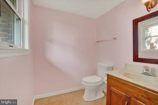 a white toilet sitting next to a bathroom sink