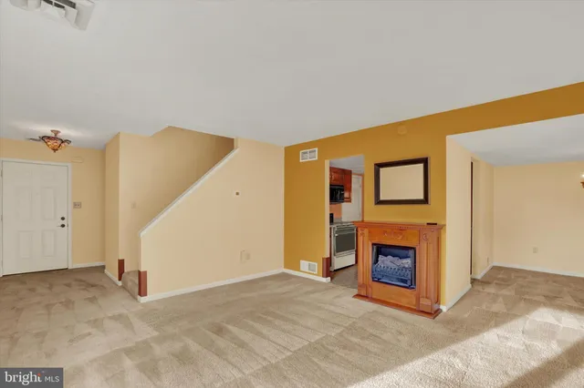 a view of empty room with a fireplace