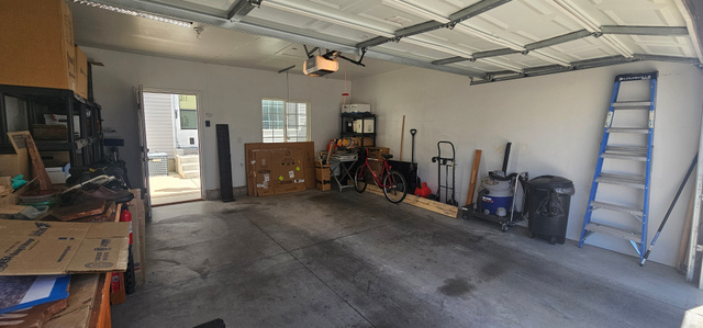 1674 Eastridge Road Price, UT 84501 - Photo 33 of 34 Spacious garage featuring a concrete floor, white walls, overhead garage door with opener, and an interior access door