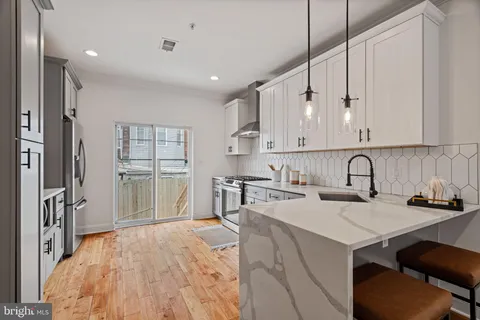 a kitchen with stainless steel appliances granite countertop a refrigerator sink and cabinets