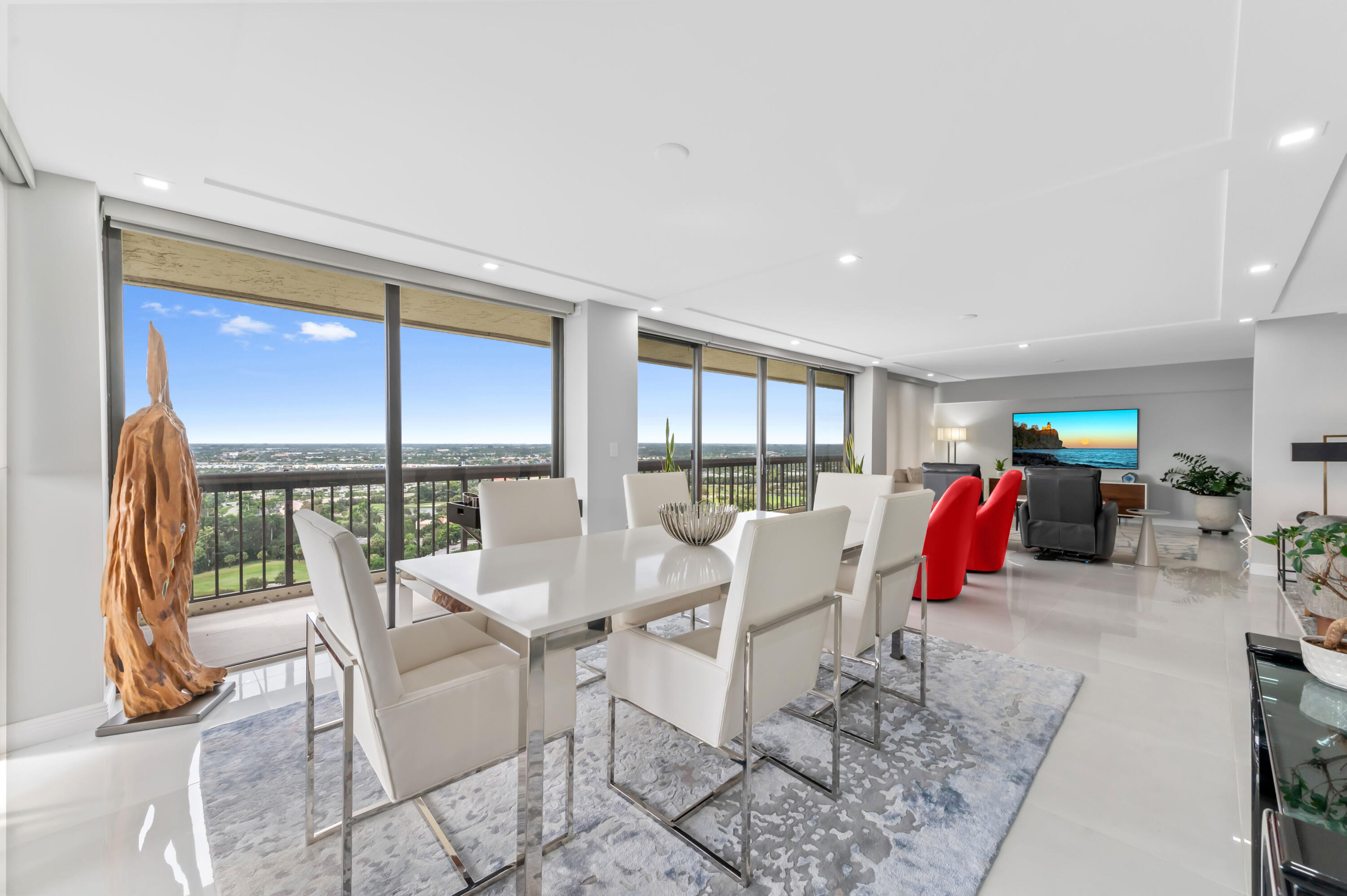 1900 Consulate Place, Unit 2104 West Palm Beach, FL 33401 - Photo 13 of 72 a view of a dining room with furniture water view and wooden floor