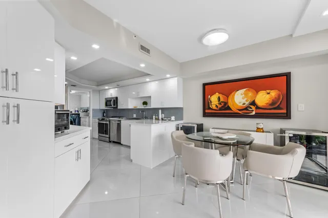 a kitchen with stainless steel appliances granite countertop a sink and a refrigerator