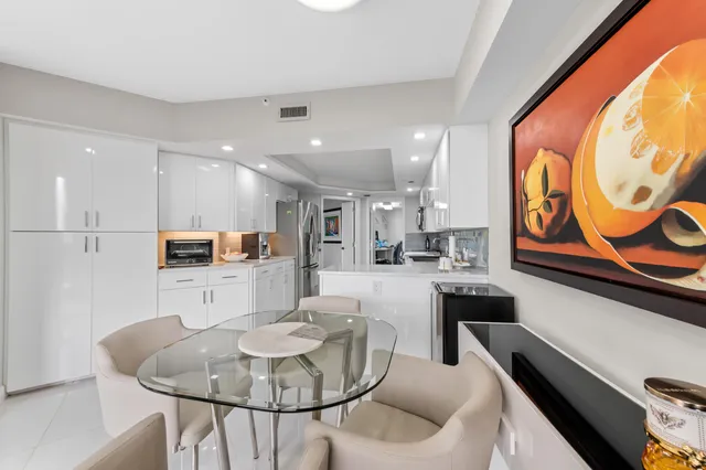 a kitchen with stainless steel appliances granite countertop a refrigerator a stove top oven a sink and dishwasher