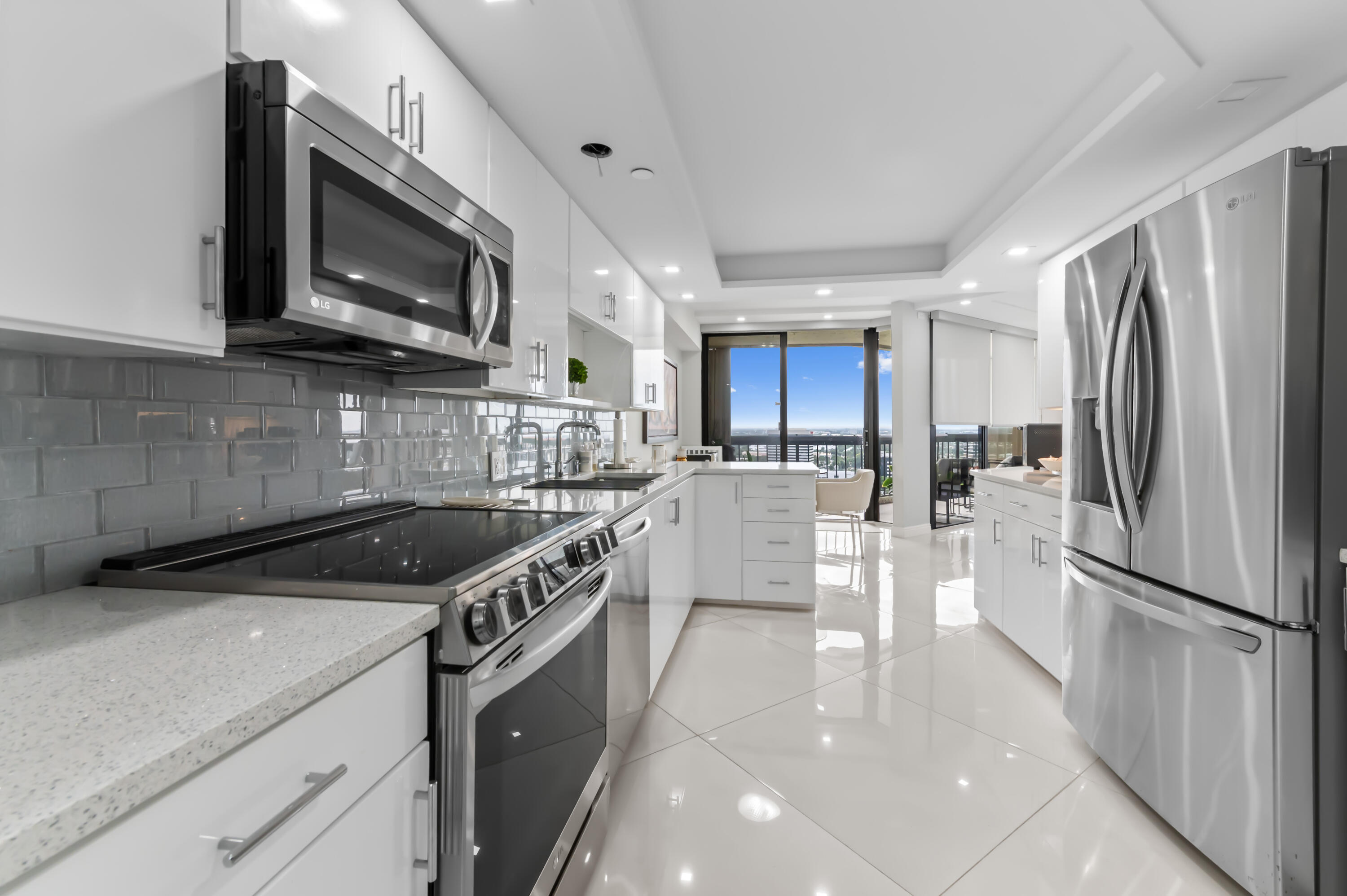 1900 Consulate Place, Unit 2104 West Palm Beach, FL 33401 - Photo 17 of 72 a kitchen with stainless steel appliances granite countertop a refrigerator a stove top oven a sink and dishwasher