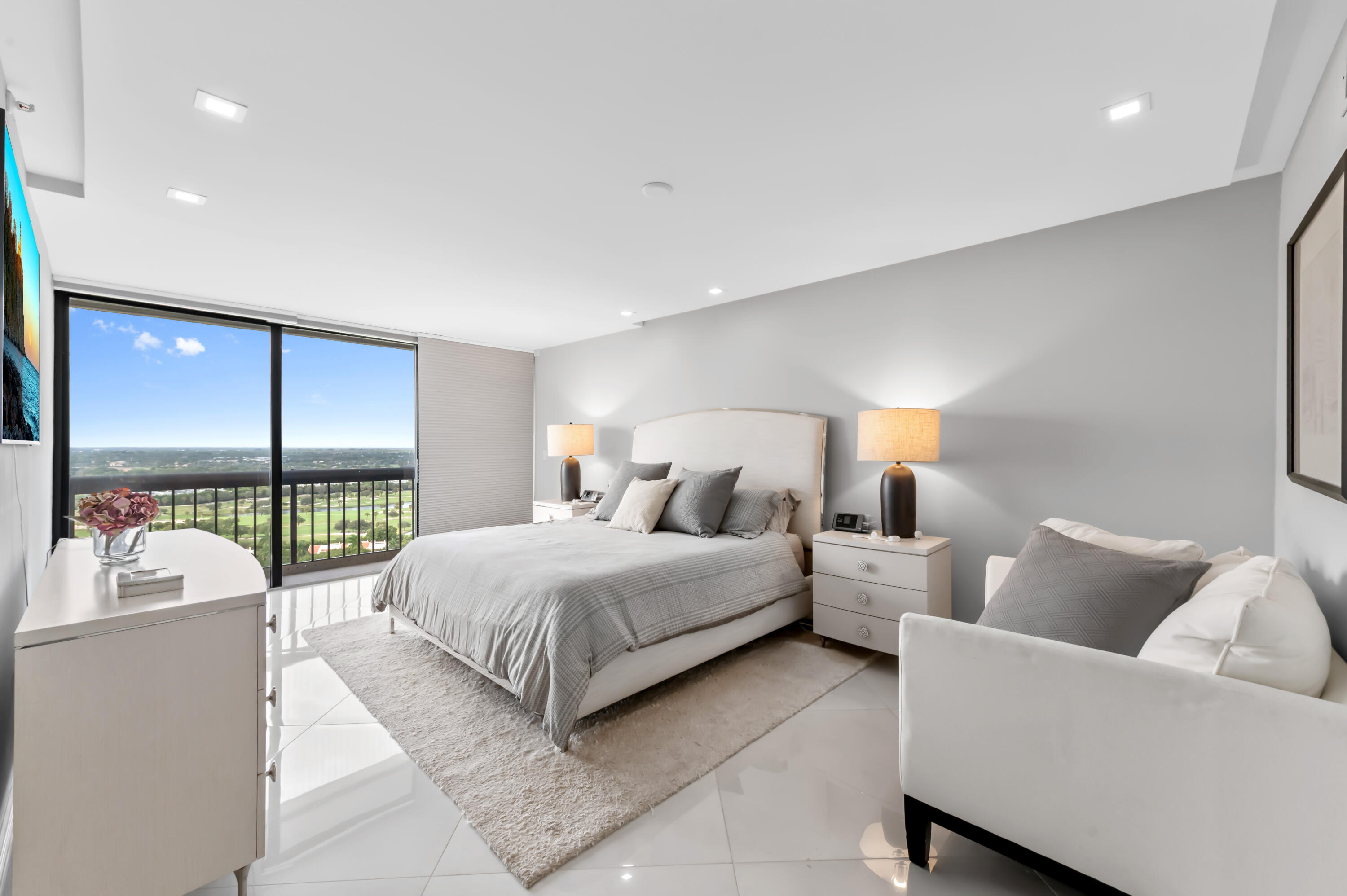 1900 Consulate Place, Unit 2104 West Palm Beach, FL 33401 - Photo 19 of 72 a spacious bedroom with a bed and large window