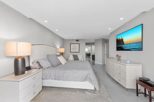 a bathroom with a sink vanity toilet and shower