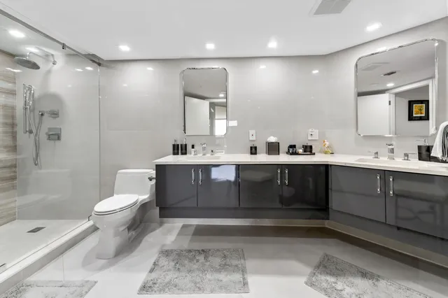 a spacious bedroom with a bed and a night stand