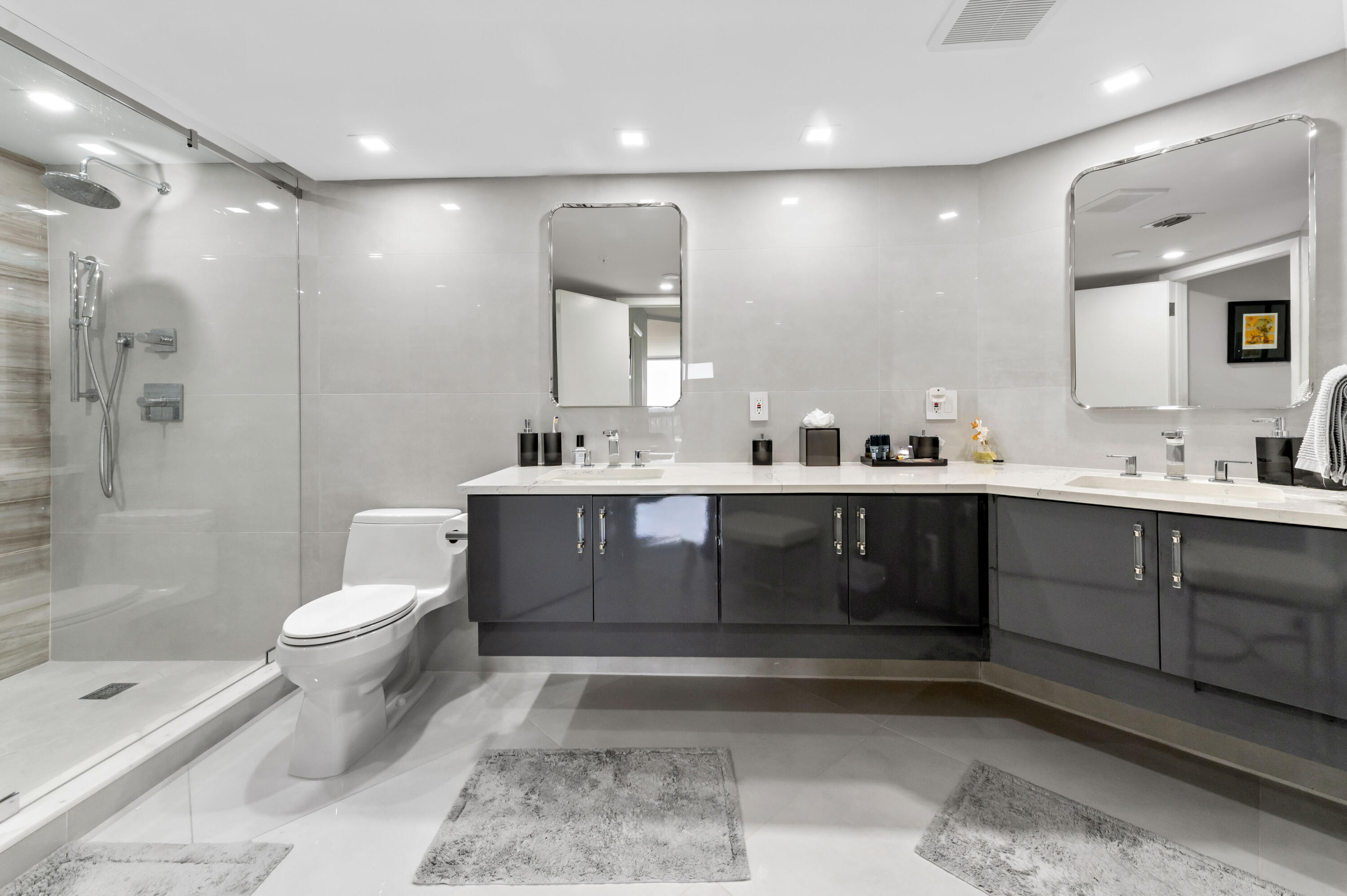 1900 Consulate Place, Unit 2104 West Palm Beach, FL 33401 - Photo 23 of 72 a bathroom with a sink a toilet and shower