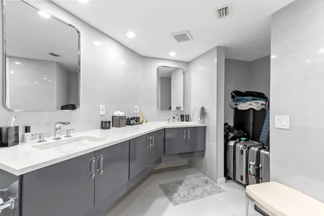 a bathroom with a sink shower and a toilet