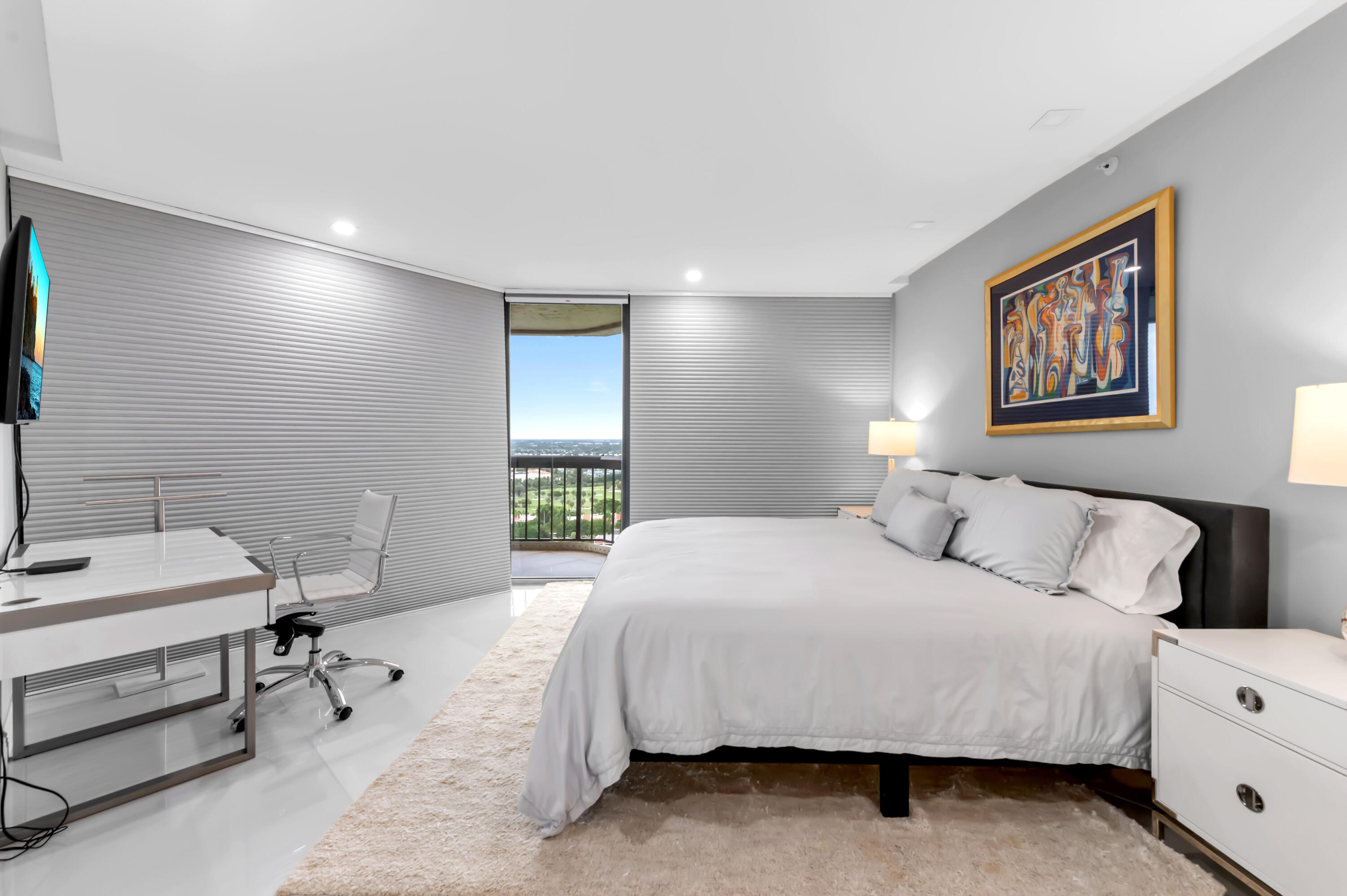 1900 Consulate Place, Unit 2104 West Palm Beach, FL 33401 - Photo 26 of 72 a bedroom with a bed and a table in it