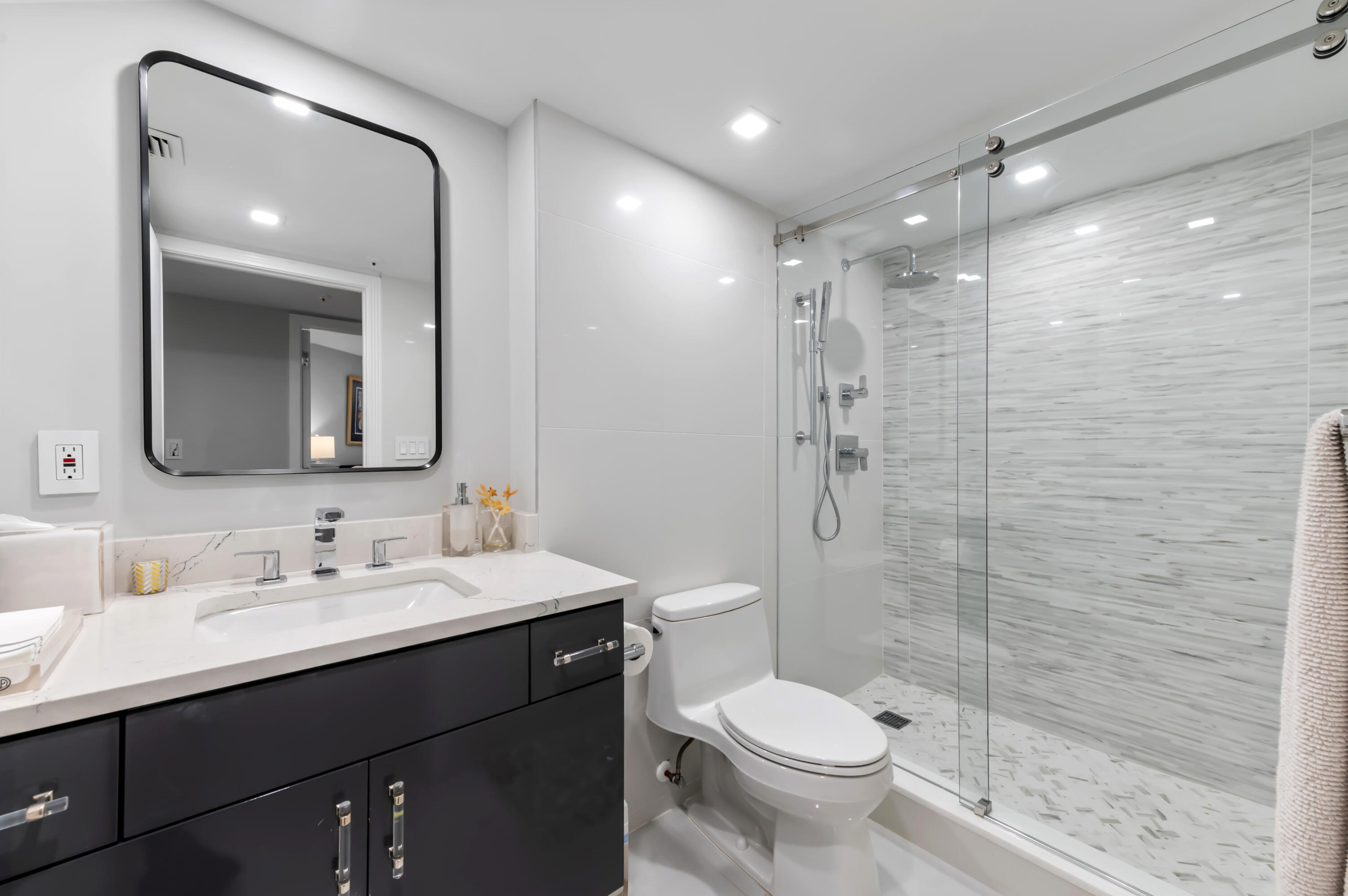 1900 Consulate Place, Unit 2104 West Palm Beach, FL 33401 - Photo 29 of 72 a bathroom with a sink shower and a toilet