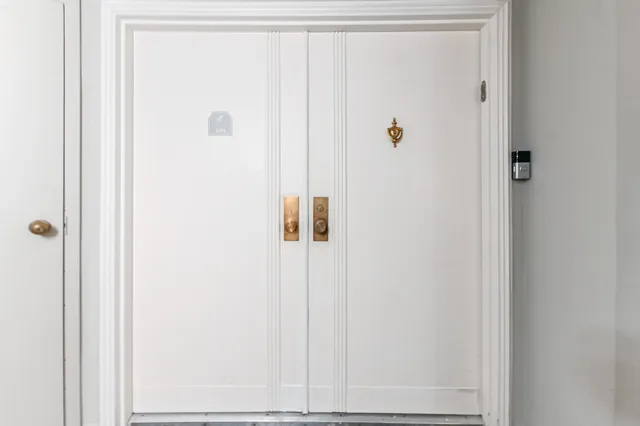 a living room with furniture floor to ceiling window and a flat screen tv
