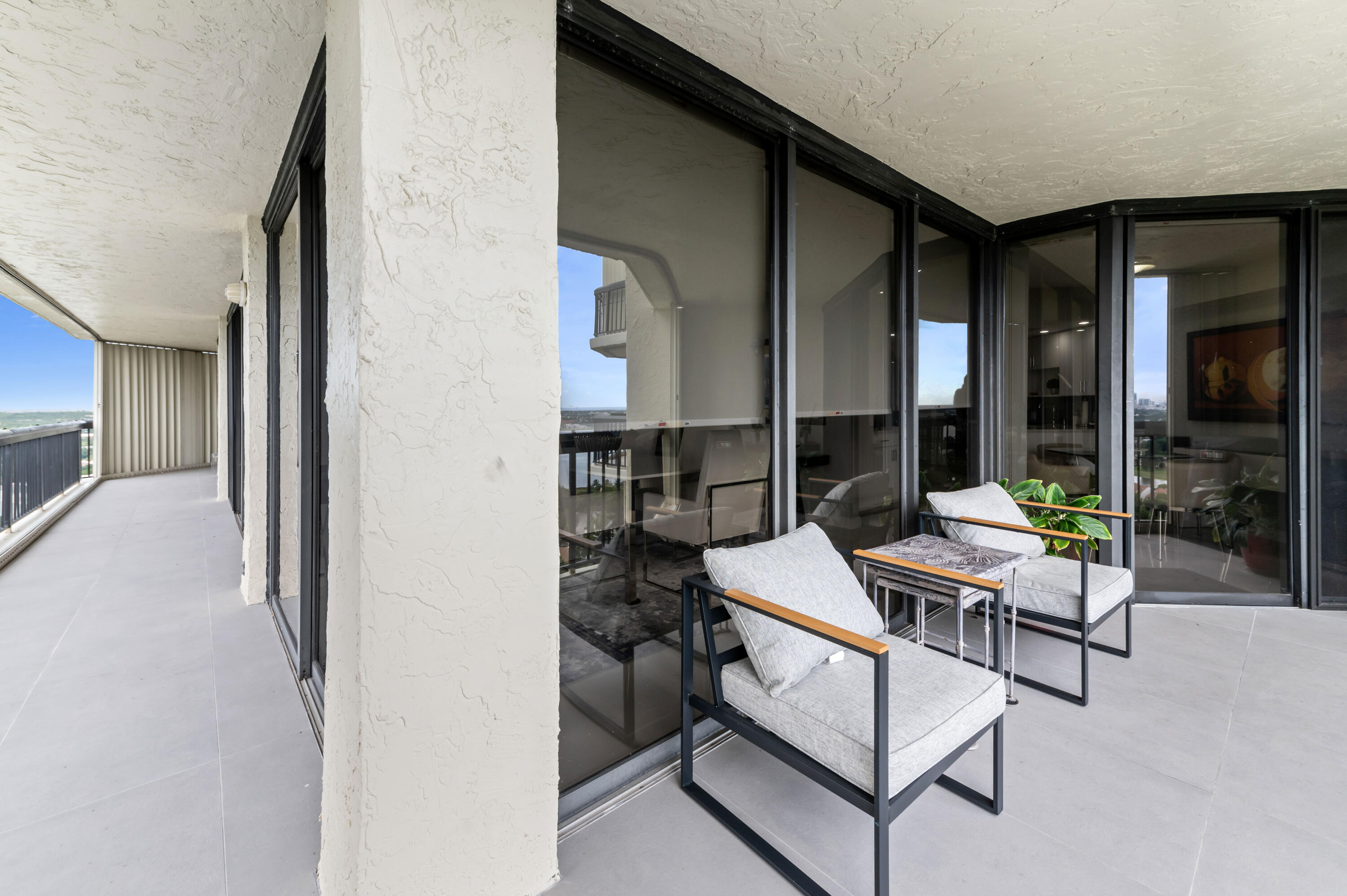 1900 Consulate Place, Unit 2104 West Palm Beach, FL 33401 - Photo 34 of 72 a outdoor space with patio the couches and a potted plant on a table