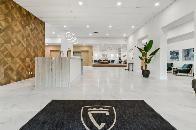a living room with furniture rug and wall painting