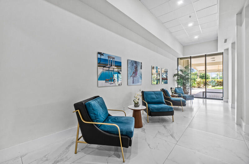 1900 Consulate Place, Unit 2104 West Palm Beach, FL 33401 - Photo 50 of 72 a living room with furniture and a large window