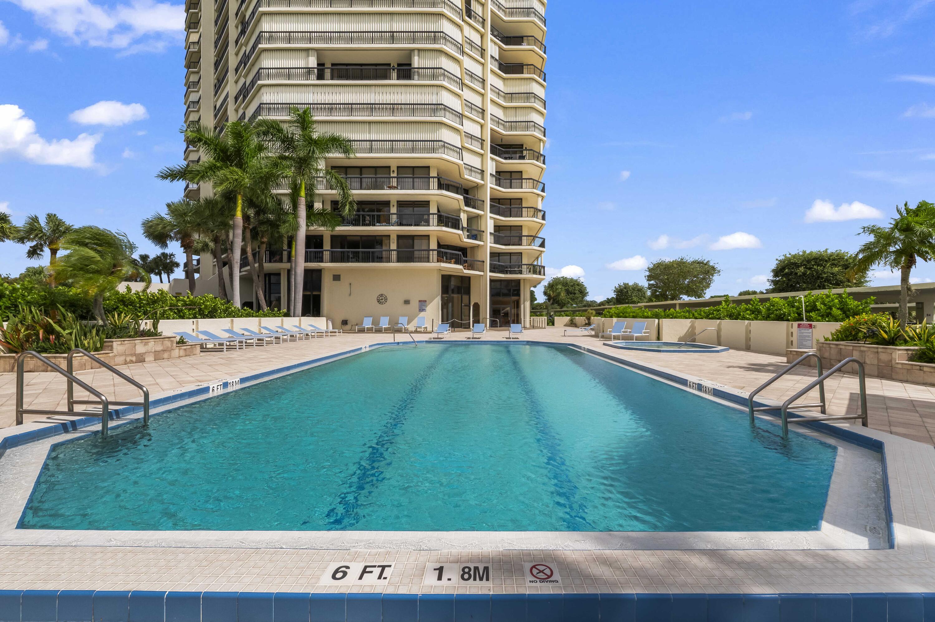 1900 Consulate Place, Unit 2104 West Palm Beach, FL 33401 - Photo 55 of 72 a view of a swimming pool with a patio