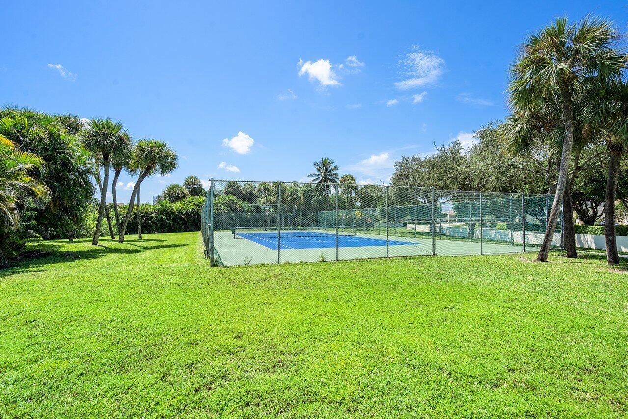 1900 Consulate Place, Unit 2104 West Palm Beach, FL 33401 - Photo 58 of 72 a view of a golf course with a lake