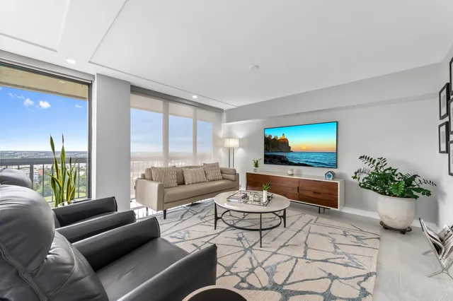 a living room with furniture and kitchen view
