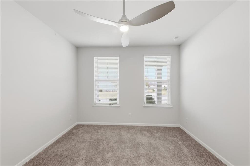 61 Rushing View Glen Dallas, GA 30157 - Photo 12 of 54 an empty room with windows and fan