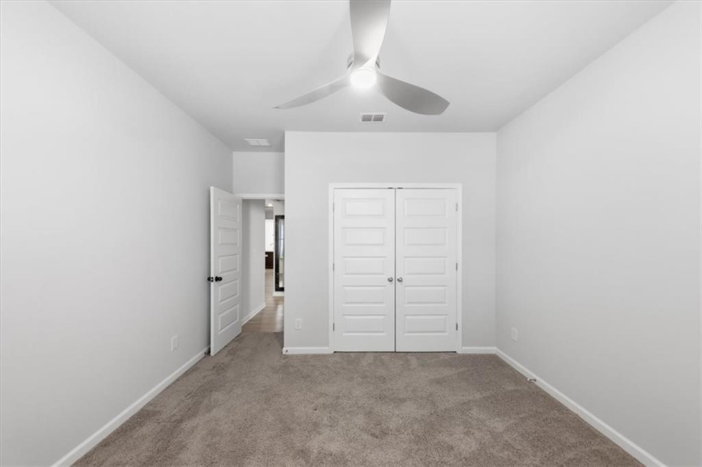 61 Rushing View Glen Dallas, GA 30157 - Photo 13 of 54 an empty room with a ceiling fan