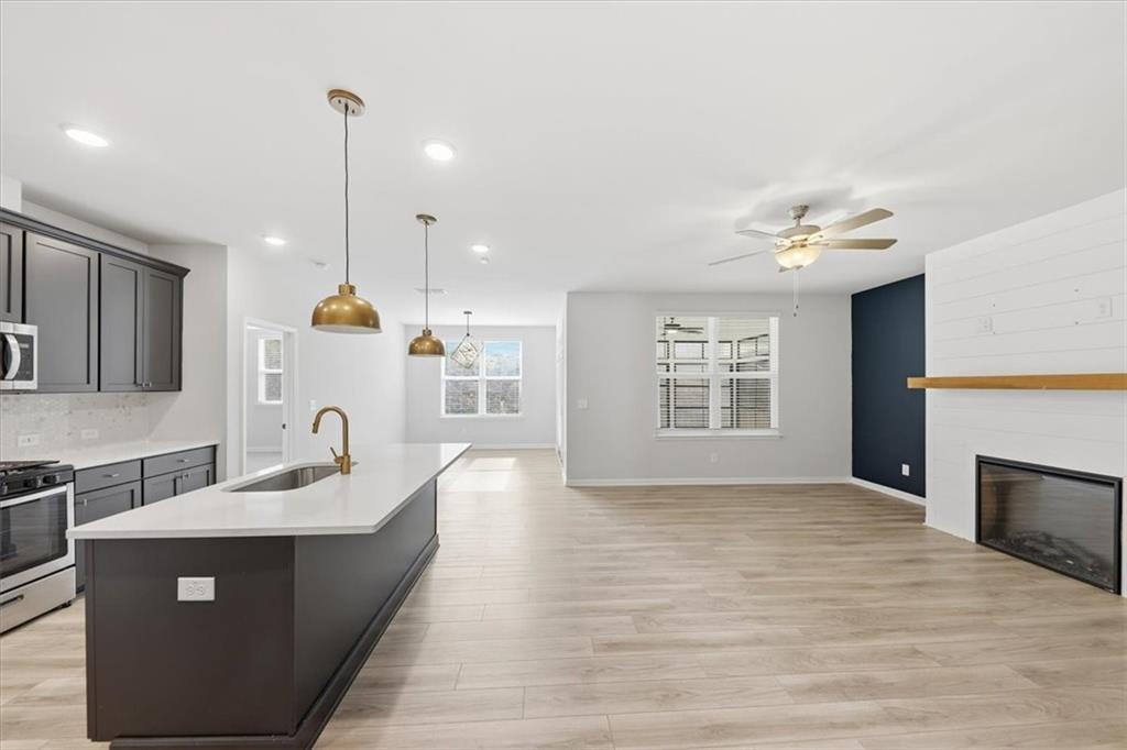 61 Rushing View Glen Dallas, GA 30157 - Photo 18 of 54 a large kitchen with kitchen island a sink stainless steel appliances and a fireplace